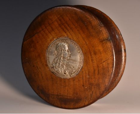 A large 19th century waisted circular table snuff box, the push-fitting cover centred by a silver coloured metal portrait rou