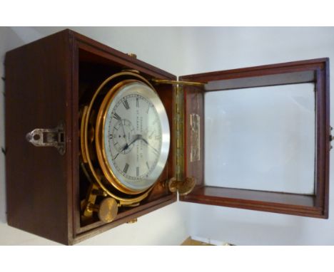 A 1920s Thomas Mercer Ltd lacquered brass cased, two day chronometer, on a gimbal fitting, faced by a silvered steel dial, in