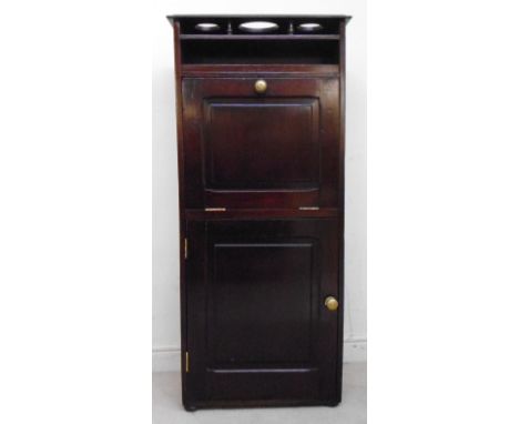 An early 20thC mahogany cabin vanitory unit, the top with three circular apertures, over an enclosed shelf, flanked by circul