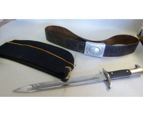 World War II German Nazi artefacts, viz. a garrison cap; a black hide belt with a white metal clasp; and an SS dagger, the bl
