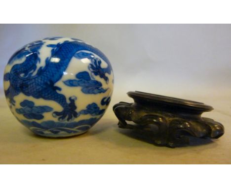 A late 19thC Chinese glazed earthenware vase of squat, bulbous form, decorated in blue and white with a dragon chasing the Sa