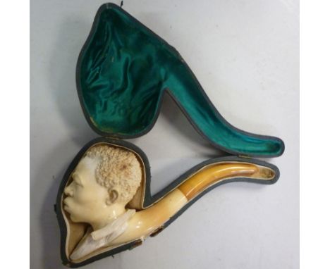 A meerschaum and amber smoker's pipe, the bowl carved as an African man's head  cased