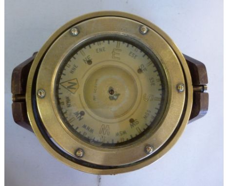 An early/mid 20thC brass cased marine compass  5.25''dia in a gimbal fitting, on a later mahogany stand