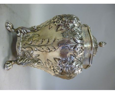 A Georgian silver tea caddy of segmented baluster form, having an upstand neck, a hinged, serpentine outlined, domed cover an