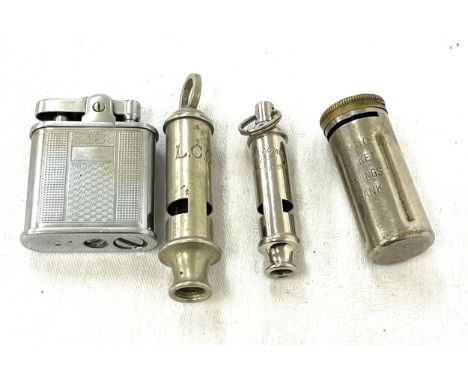 Tray of items containing The Acme guide whistle, L.C.C whistle, vintage lighter, magic pocket savings banks 