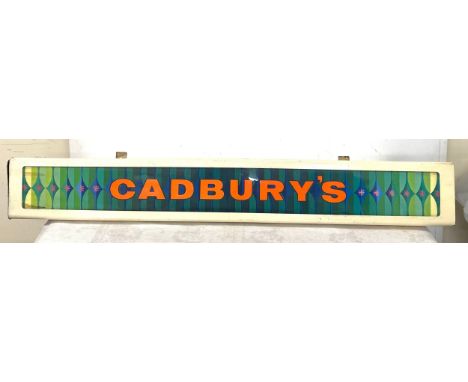 Metal and perspex light up Cadburys advertising sign, in need of re-wiring, approximate length 36 inches, Height 6 inches 