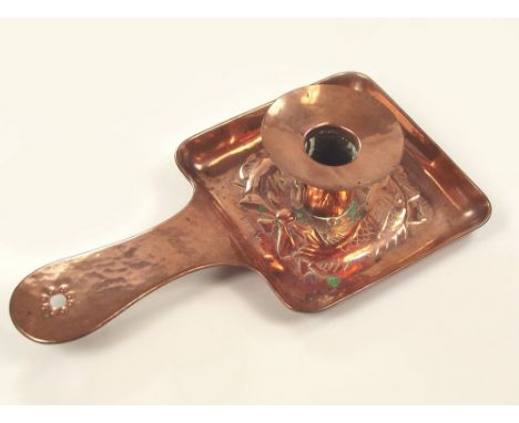 NEWLYN COPPER. A Newlyn Copper chamber stick decorated with two fish, stamped NEWLYN, unmarked. 11 x 21cm.
