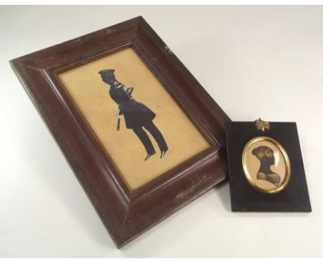 SILHOUETTES.A full length silhouette portrait of a cavalry officer, highlighted in white, indistinctly pencil signed, 22 x 13