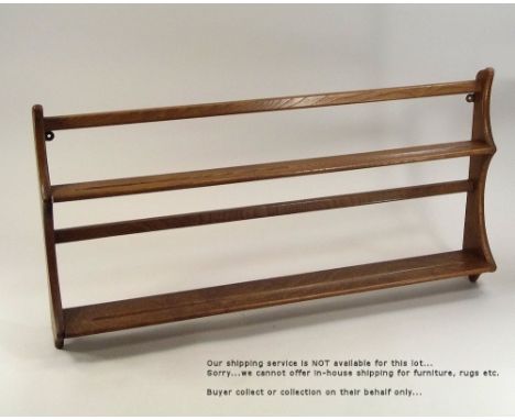 ERCOL. An Ercol, light elm, wall mounted plate rack. 50 x 97cm.