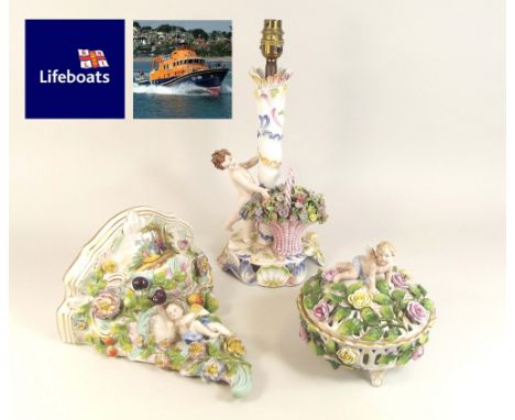 CONTINENTAL PORCELAIN.Cherub & floral decorated Continental porcelain: a table lamp, a wall bracket & a lidded bowl.NOTE: OUR