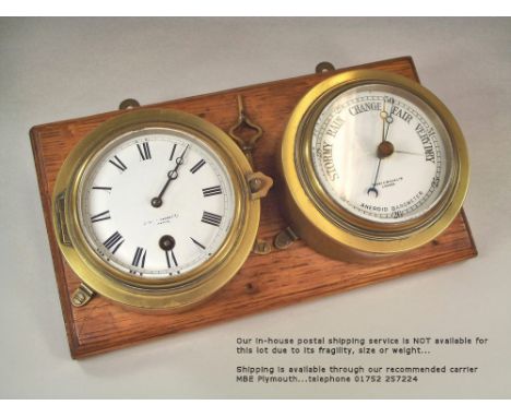 CLOCK/BAROMETER. A Short & Mason Ltd. bulkhead clock, with matching aneroid barometer, both mounted on an oak wall panel, wit
