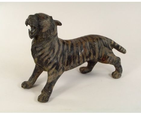 BRONZE TIGER. A patinated bronze tiger. Length 30cm.