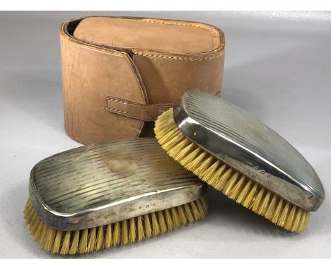 Pair of hallmarked silver clothes brushes with engine turned decoration hallmarked for London by maker Charles Packer &amp; C