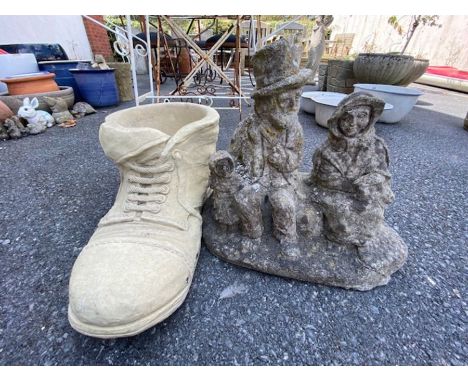 Concrete boot planter and a garden statue