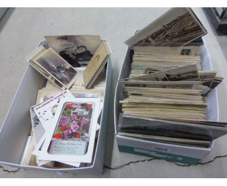Two shoe boxes of vintage postcards and photos including UK, the world, portrait etc