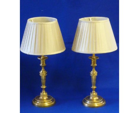 A pair of First French Empire period style ormolu Candlesticks of neo-classical inspiration, tapering main bodies with restra