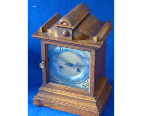 A late 19th Century oak cased eight day Mantel Clock with original pendulum and key, the movement striking on a gong, the sil