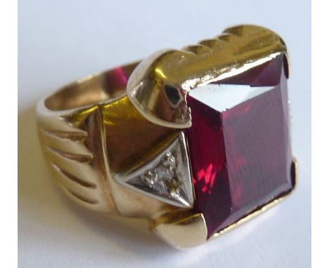 A heavy 14 carat yellow gold Ring centrally set with an oblong wine red stone of very good colour (possibly a ruby), the ston