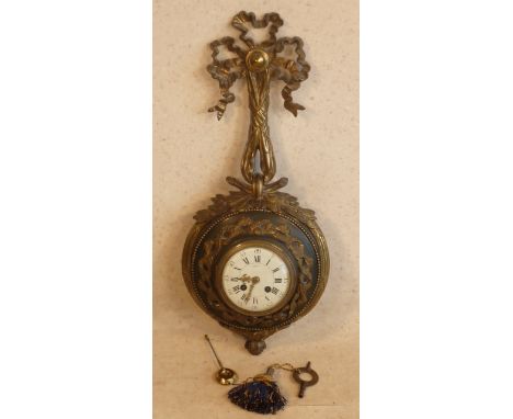 An early 20th Century French gilt metal mounted Cartel Clock in Classical style, the gilt metal ribbons above a white enamel 