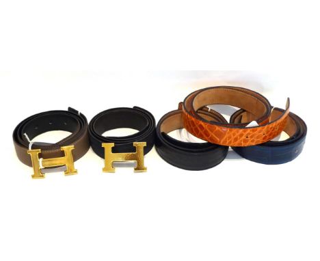 A Hermes Leather Taupe/Mushroom Belt, and another Navy Blue Example; two Hermes H Gilt Metal Belt Buckles, with hammered and 