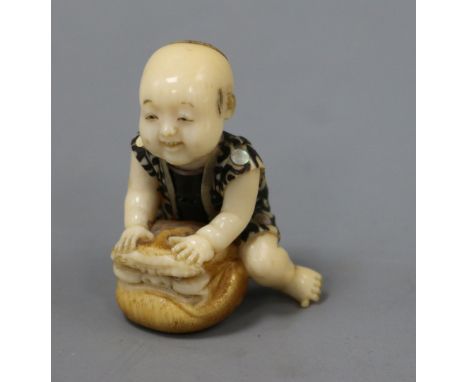 A Japanese ivory inlaid figurative netsuke