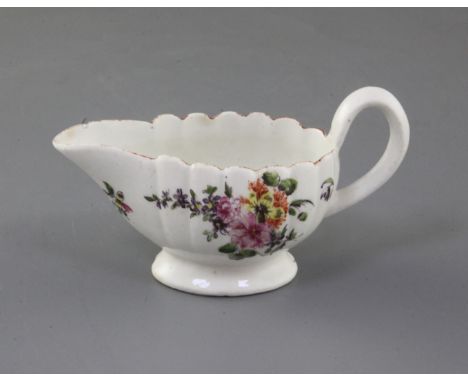 A rare Derby scalloped butterboat, c.1758, painted in 'Cotton-stem painter' style with a loose bouquet of flowers and floral 