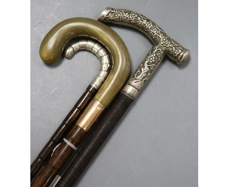 Two silver mounted and handled walking sticks and a horn, 9ct mounted walking stick