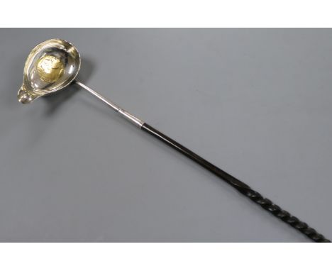 An 18th century white metal toddy ladle, the bowl inset with Queen Anne silver half crown, 38cm.