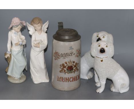 Two Nao figures and a pair of Staffordshire dogs and a beer stein