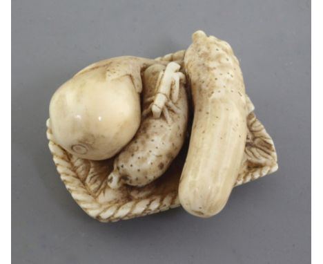 A Japanese ivory netsuke of vegetables on a woven tray, Meiji period, signed Komei, l. 3.7cm