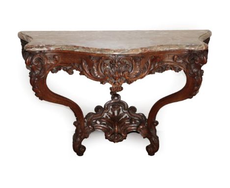 A French Louis XV Style Carved Walnut Console Table, 3rd quarter 19th century, the pink veined Turquin serpentine marble top 