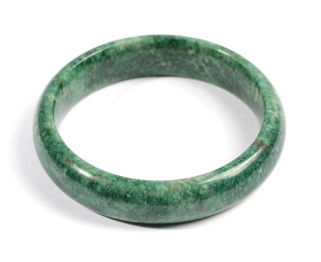 A Jade Bangle, of varied green tones, inner diameter 6.5cm  Provenance: Purchased by the vendor's family in the 1950's.   The