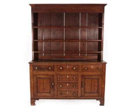  ~ A George III Oak Dresser and Rack, late 18th century, with three fixed shelves, the base with an arrangement of six drawer