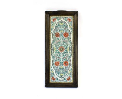 A Chinese Doucai Porcelain Plaque, Qing Dynasty, painted with flowering tendrils within a lobed oval scroll border and foliat