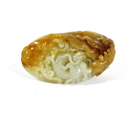 A Chinese Celadon and Russet Jade Pebble, Qing Dynasty, carved with carp amongst waves, 8cm long.  Some minor surface abrasio