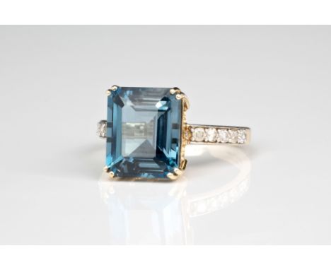 A 9ct gold, London Blue quartz and diamond ring, the emerald cut quartz claw set over diamond set shoulders, ring size N.