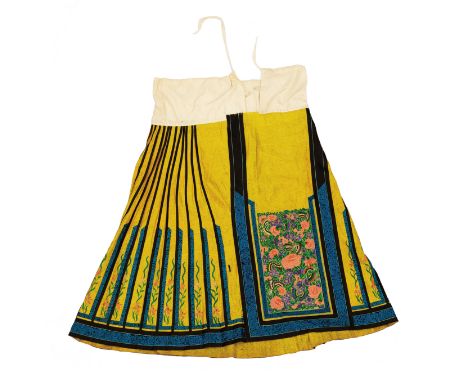 A Chinese silk embroidered wedding skirt, early 20th century, the yellow damask and black bordered pleats with silk embroider