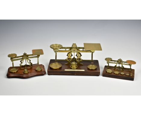 Three sets of early 20th century brass postal scales and weights, two by S Mordan &amp; Co, each of typical balance form, the