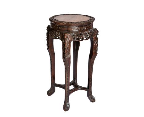 A Chinese carved hardwood jardiniere stand with inset marble top, 19th century, the scalloped circular top with foliate carve