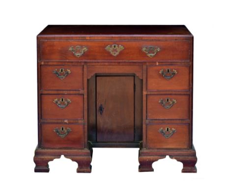 A George III mahogany kneehole dressing table, the caddy moulded top over a fitted full width top drawer with various open an