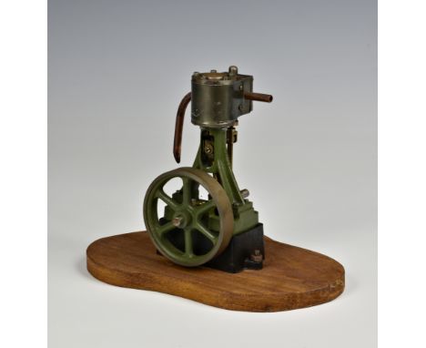 A well engineered stationary vertical single cylinder live steam engine, single spoked flywheel to side, painted khaki green,