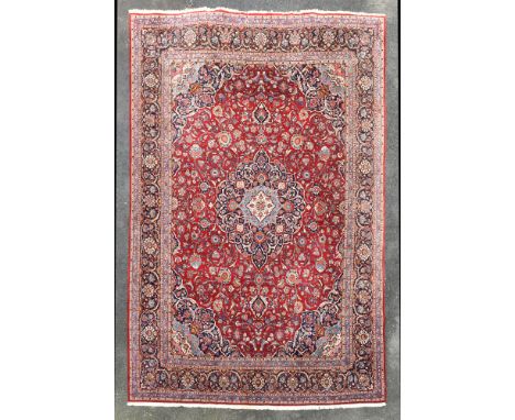 A large Iranian Kashan carpet, the dark and light blue and ivory pendant medallion and conforming spandrels on an all over fl