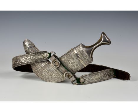 A 20th century Omani Khanja, waisted horn hilt with silver mounts, decorative silver scabbard with four cast rings, silver em