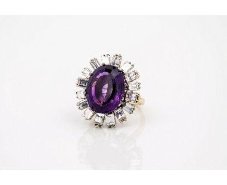 A fine amethyst and diamond vintage cluster ring, in white gold, the oval step-cut amethyst, approx. 16 x 13mm., within a flo