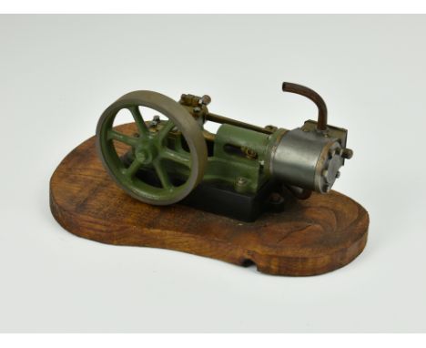 A well engineered stationary horizontal single cylinder live steam engine, single spoked flywheel to side, painted khaki gree