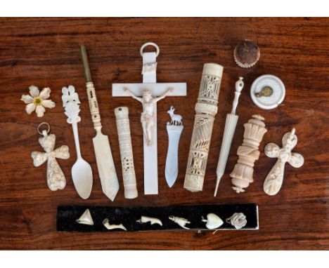 A small group of ivory sewing accessories, 19th century, comprising a pierced ivory bodkin case and bodkin; a basket shaped p