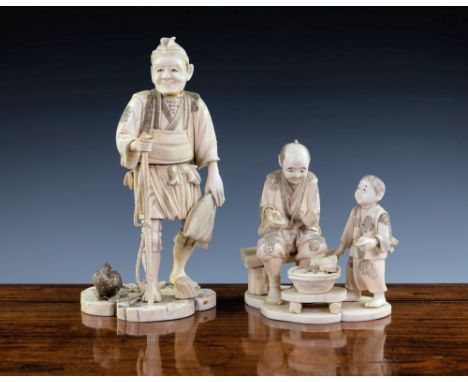 A Japanese carved ivory okimono of a farmer and boy, Meiji period (1868-1912), the farmer seated on a wooden bench with the b