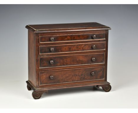 A 19th century miniature mahogany salesman sample/apprentice piece chest of drawers, the moulded top above four graduated dra