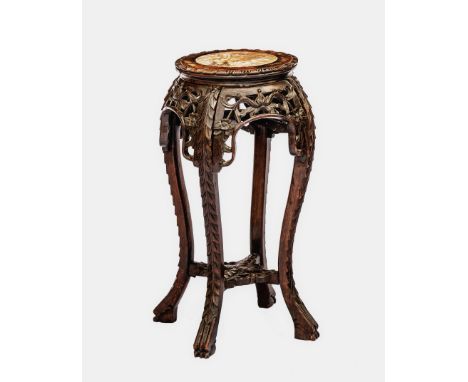A Chinese carved hardwood jardiniere stand with inset marble top, 19th century, the circular top with foliate carved border o