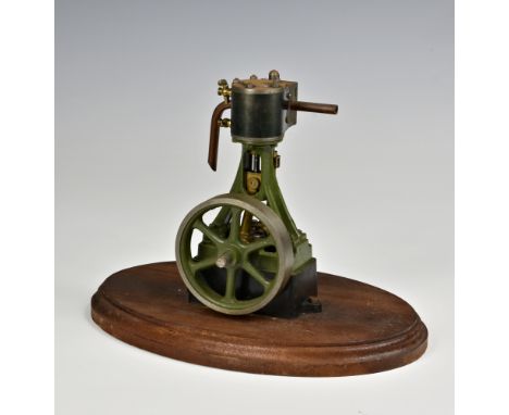 A well engineered stationary vertical single cylinder live steam engine, single spoked flywheel to side, painted khaki green,